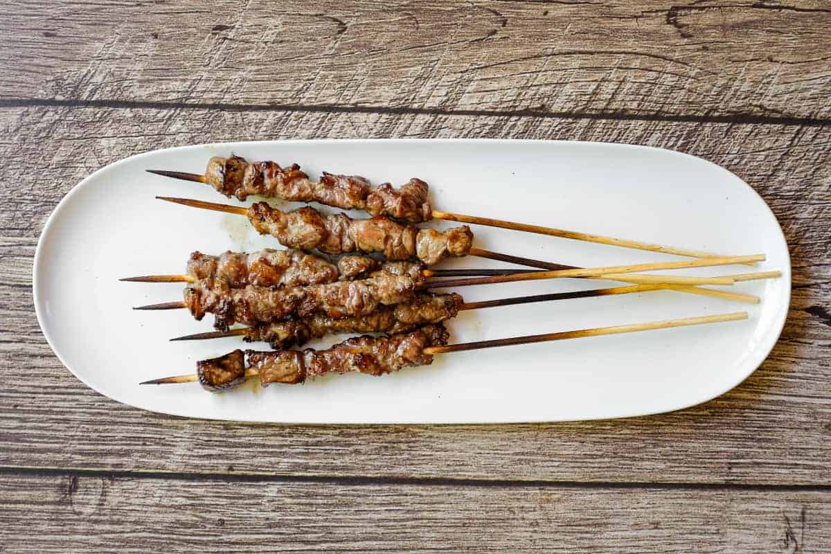 Finished arrosticini skewers resting after grilling