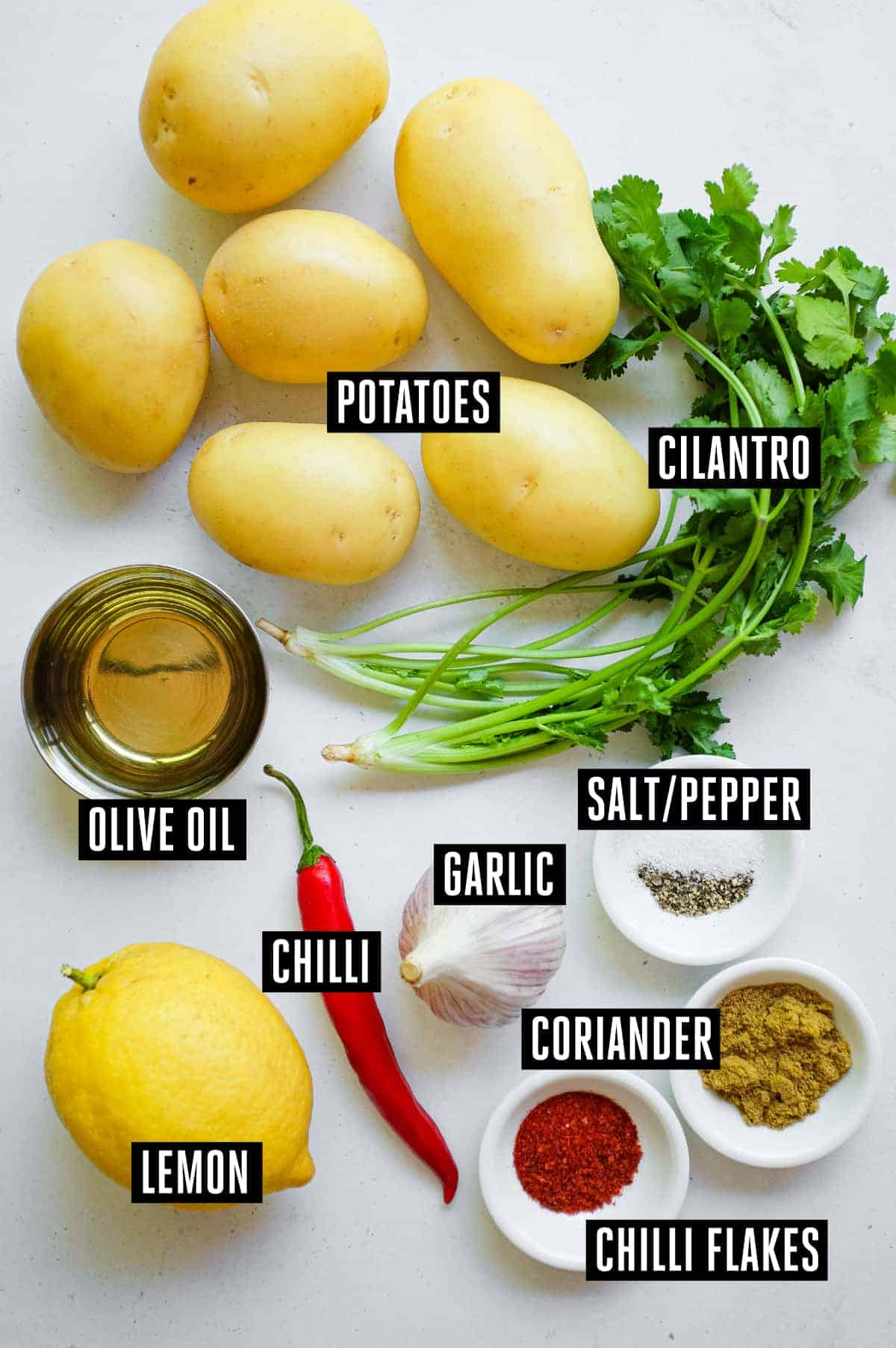 Batata Harra (Lebanese Spicy Potatoes) | cookeatworld.com The ingredients for Lebanese barara harra: Potatoes, cilantro, oil, garlic, coriander, salt & pepper, lemon, chilli, and chilli flakes.