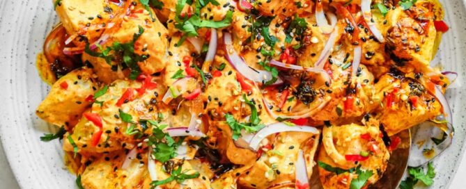 A platter of creamy Aloo Chukauni, a Nepali potato and yoghurt salad garnished with a vibrant spiced oil