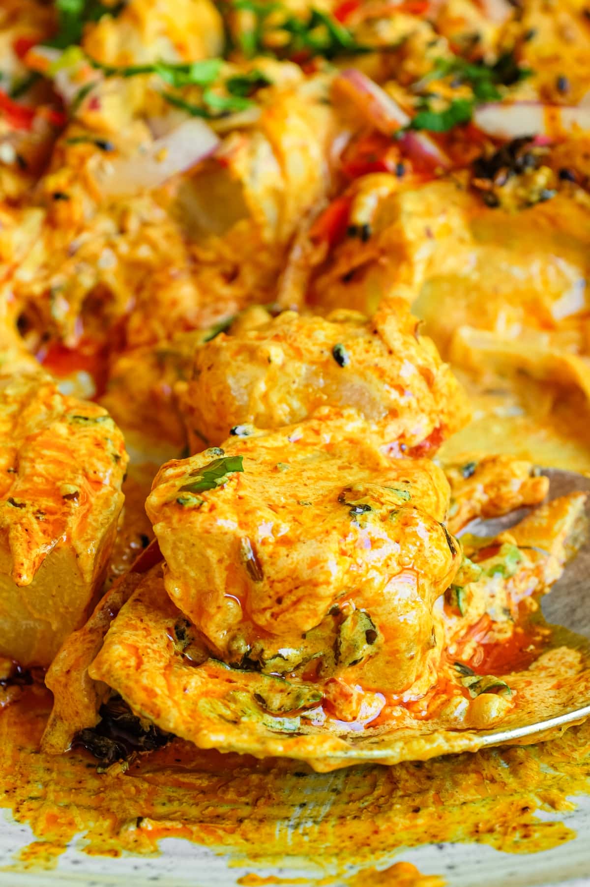 A platter of creamy Aloo Chukauni, a Nepali potato and yoghurt salad garnished with a vibrant spiced oil