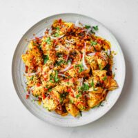 A platter of creamy Aloo Chukauni, a Nepali potato and yoghurt salad garnished with a vibrant spiced oil