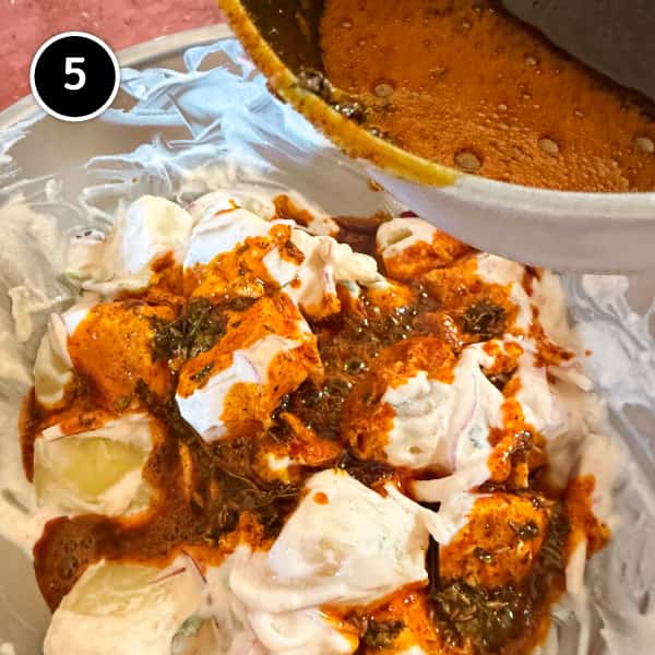 Aloo Chukauni – Nepali Yoghurt-Spiced Potatoes | cookeatworld.com A hot spiced tadka being poured over the cold yoghurt potatoes