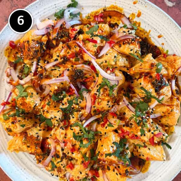 Aloo Chukauni – Nepali Yoghurt-Spiced Potatoes | cookeatworld.com A platter of creamy Aloo Chukauni, a Nepali potato and yoghurt salad garnished with a vibrant spiced oil