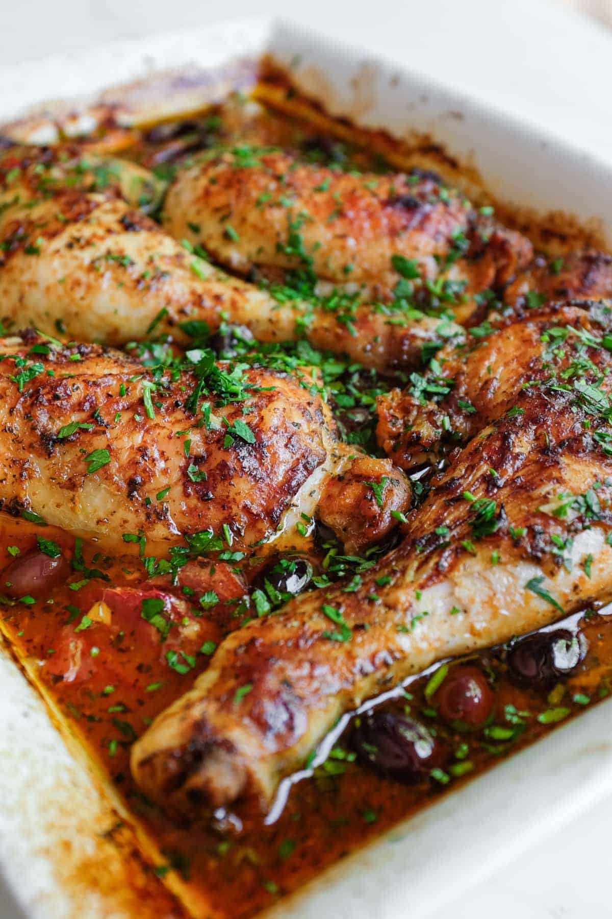 A close up of a baking dish containing Moroccan harissa chicken.