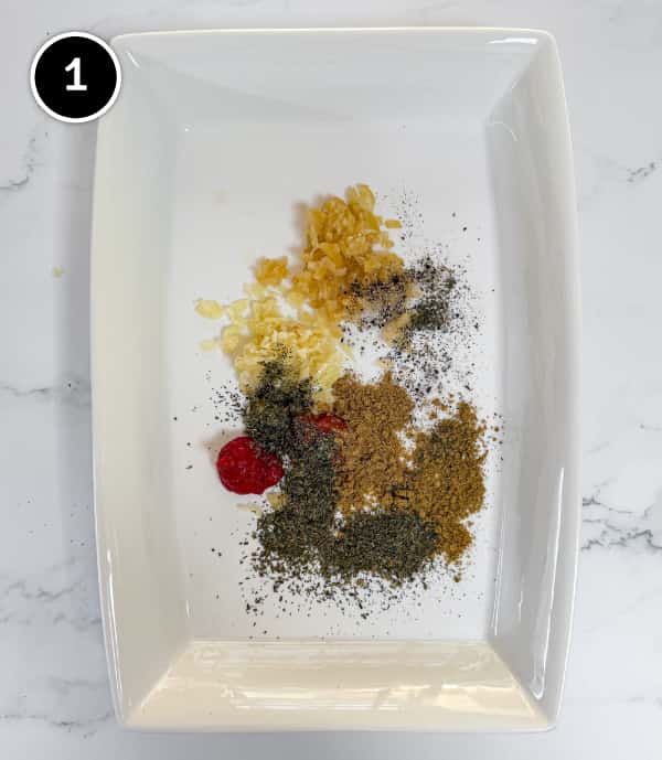 Harissa Chicken | cookeatworld.com The spices, garlic and preserved lemons and scattered directly into the baking dish.