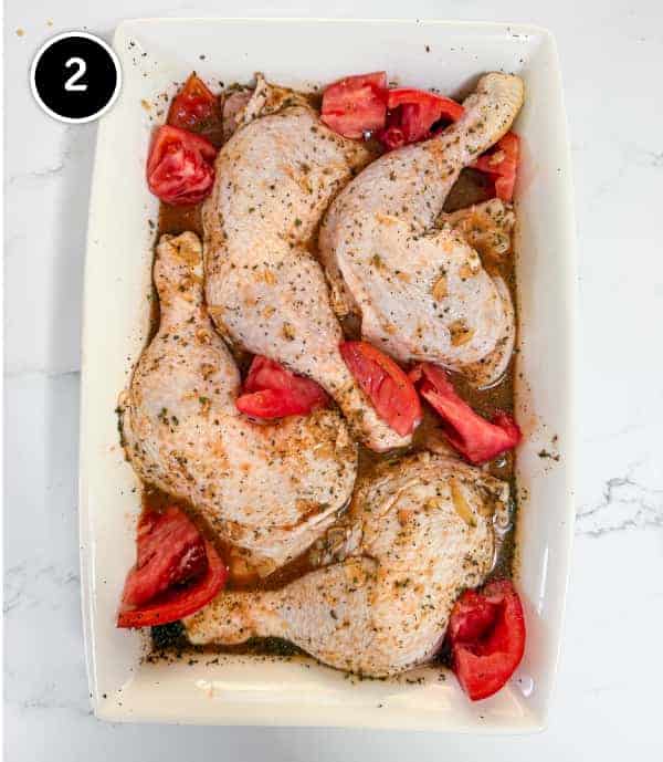 Harissa Chicken | cookeatworld.com The chicken maryland quarters are arranged in the marinade and the tomato pieces nestled in the gaps.
