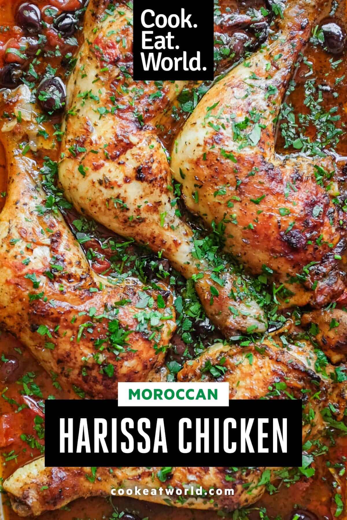 Four chicken quarters sit in a tangy red harissa sauce, scattered with fresh parsley.