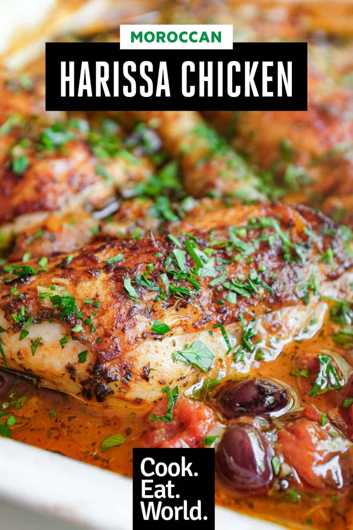 A detail shot of a chicken quarter bathed in a vibrant moroccan harissa sauce.