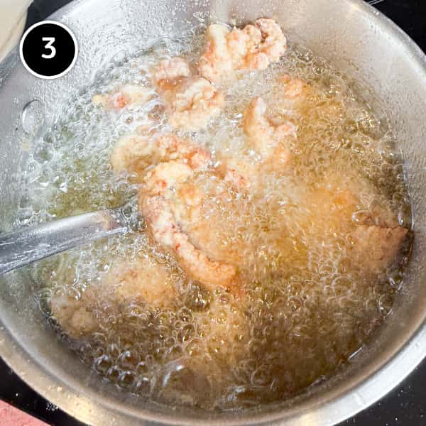Karaage Chicken (Japanese Fried Chicken) | cookeatworld.com Karaage chicken frying in hot oil