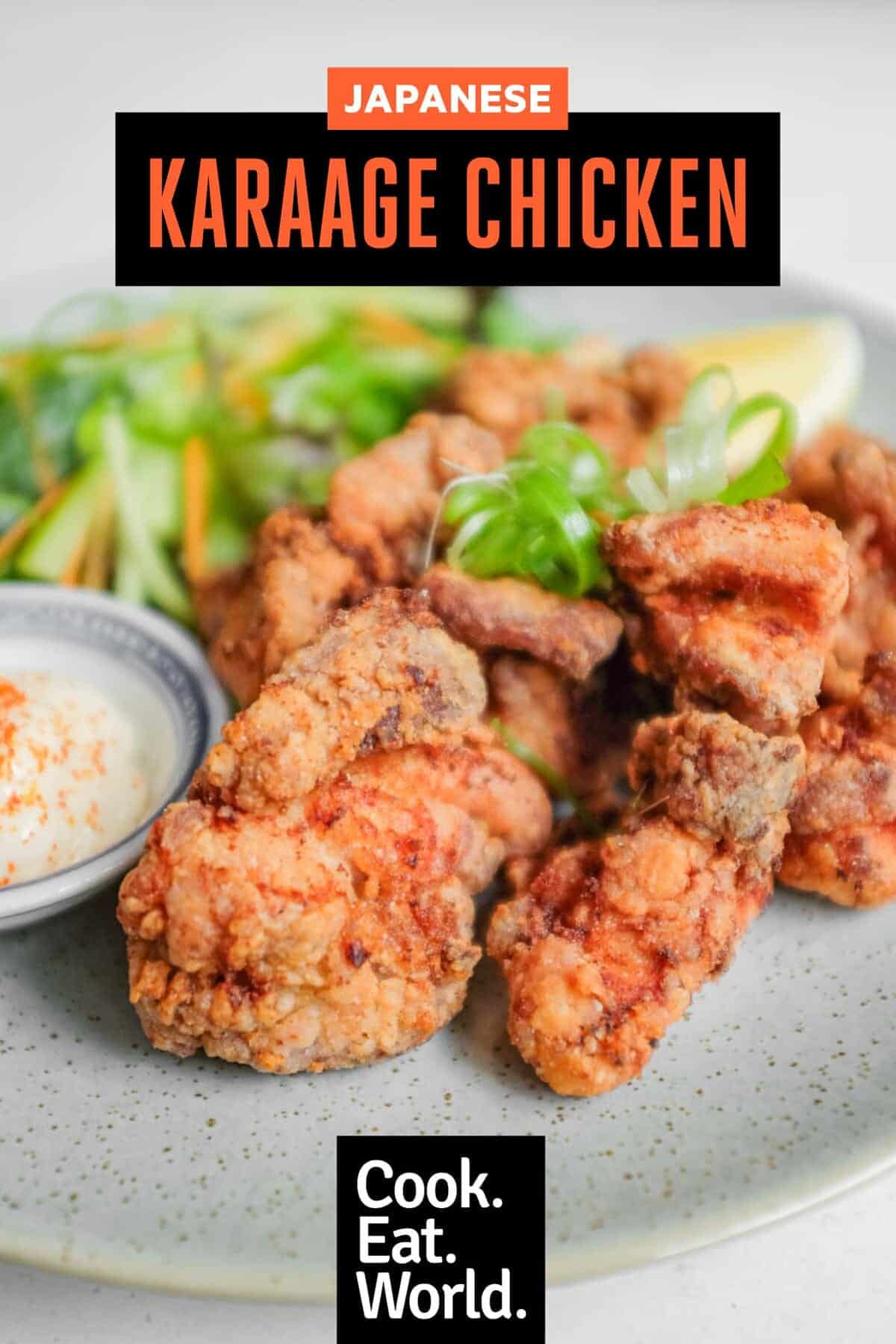 A plate of Japennese karaage chicken with a side salad, lemon wedge, and mayonnaise