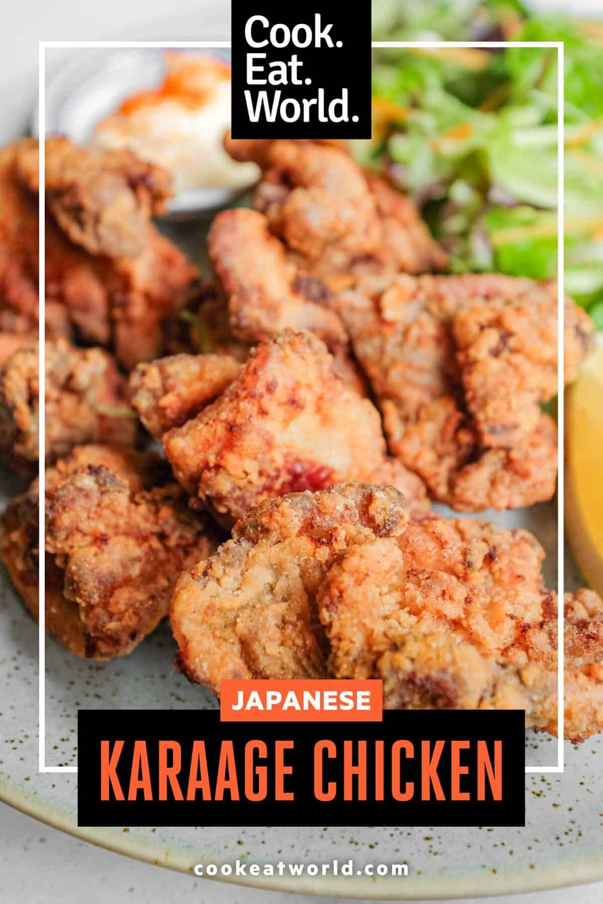 A plate of Japennese karaage chicken with a side salad, lemon wedge, and mayonnaise