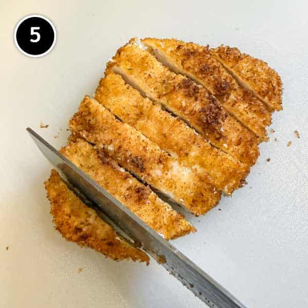 Chicken Katsudon | cookeatworld.com Slicing the chicken katsu into strips.