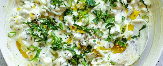 Indian cucumber raita with creamy yoghurt, fresh herbs and mustard oil garnish