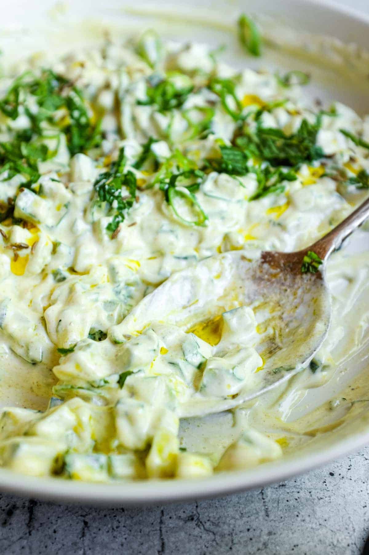 Simple Indian cucumber raita served with fresh mint and green onion