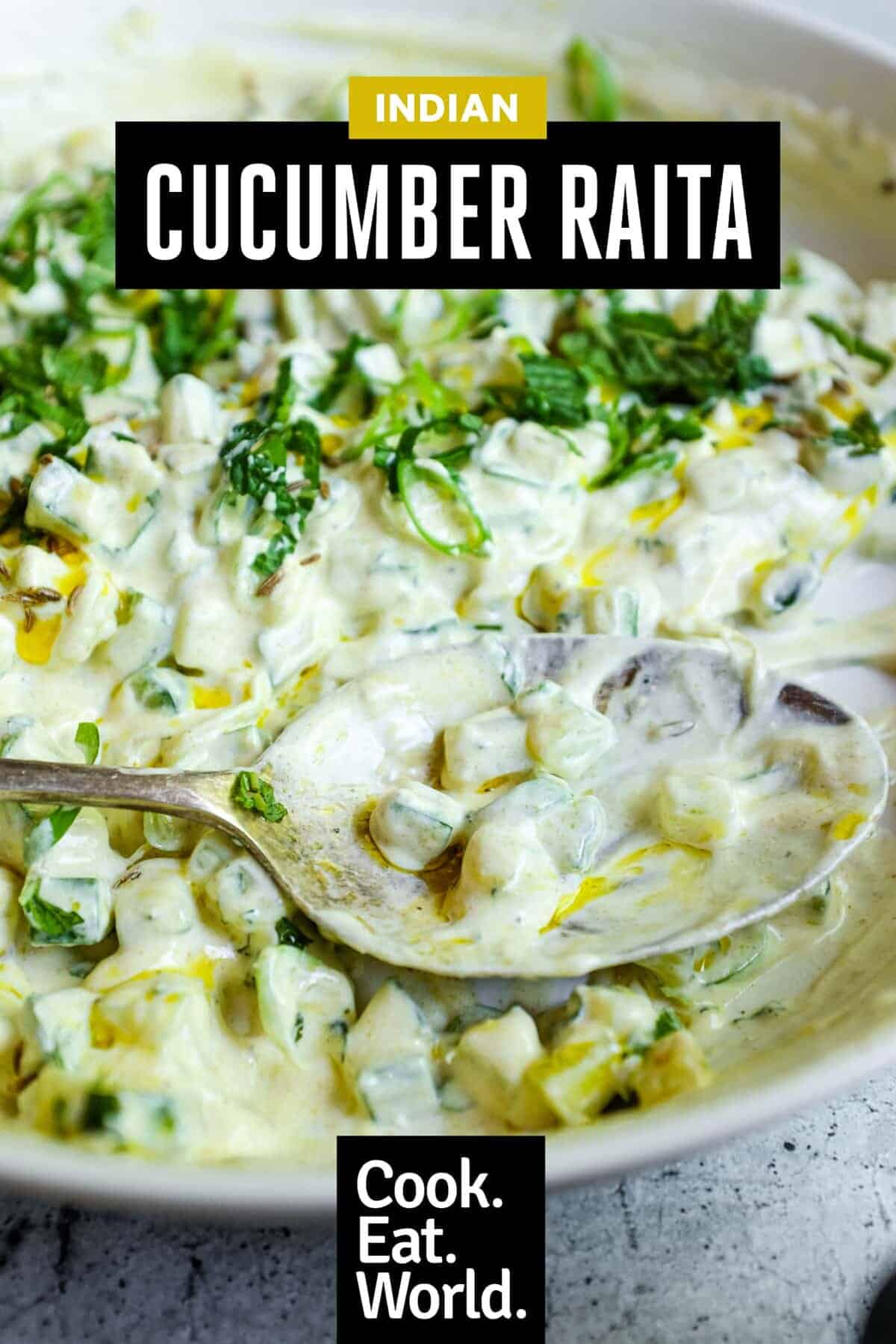 Cooling Indian cucumber raita garnished with chopped mint and green onions