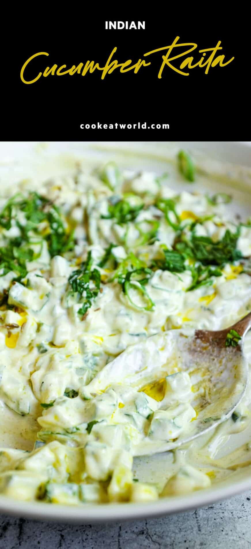 Small bowl of cucumber raita made with yoghurt, garnished with fresh mint and spring onions