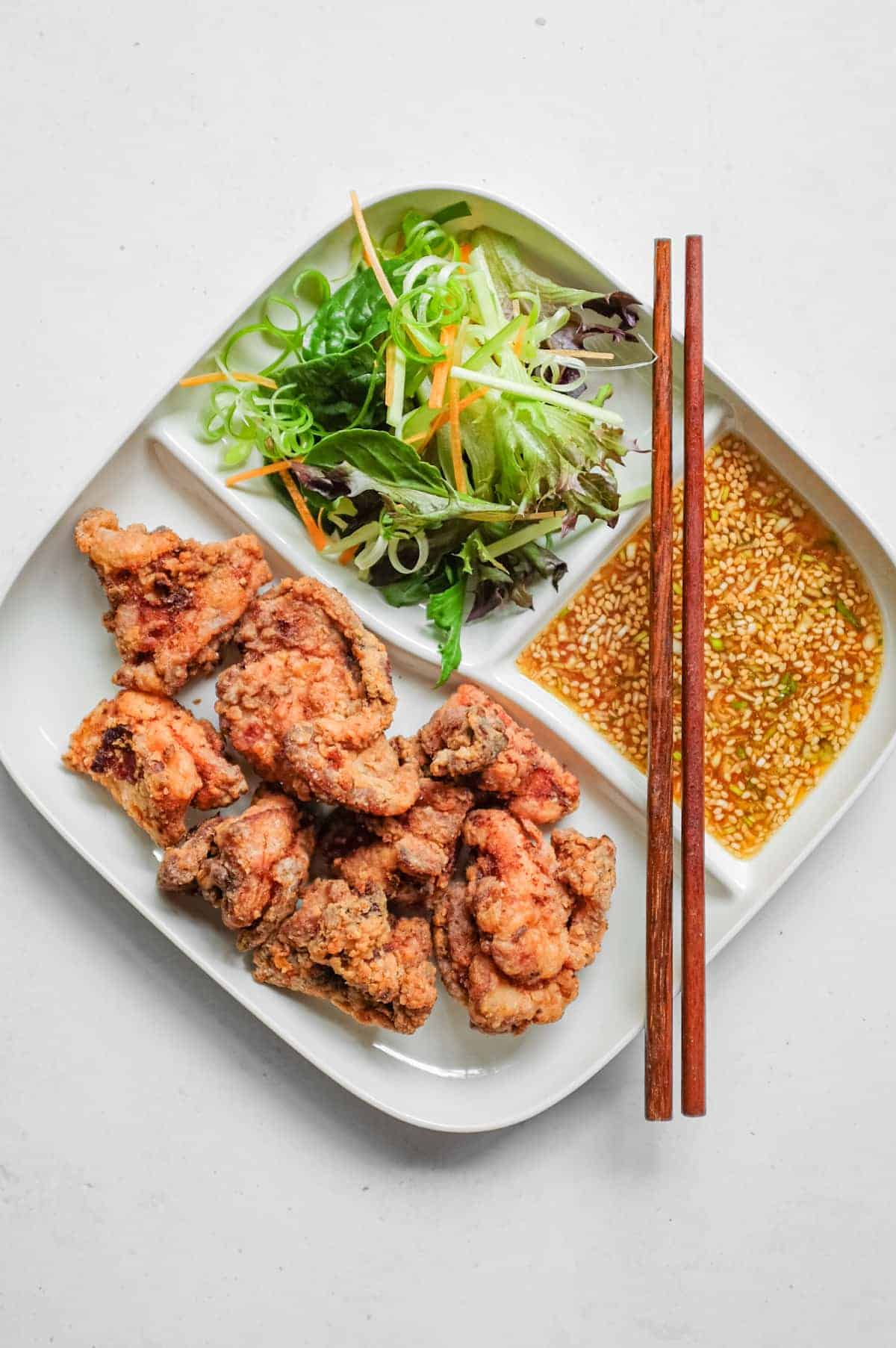 A bento style plate which holds yurinchi chicken, salad and a special tangy yurinchi sauce.