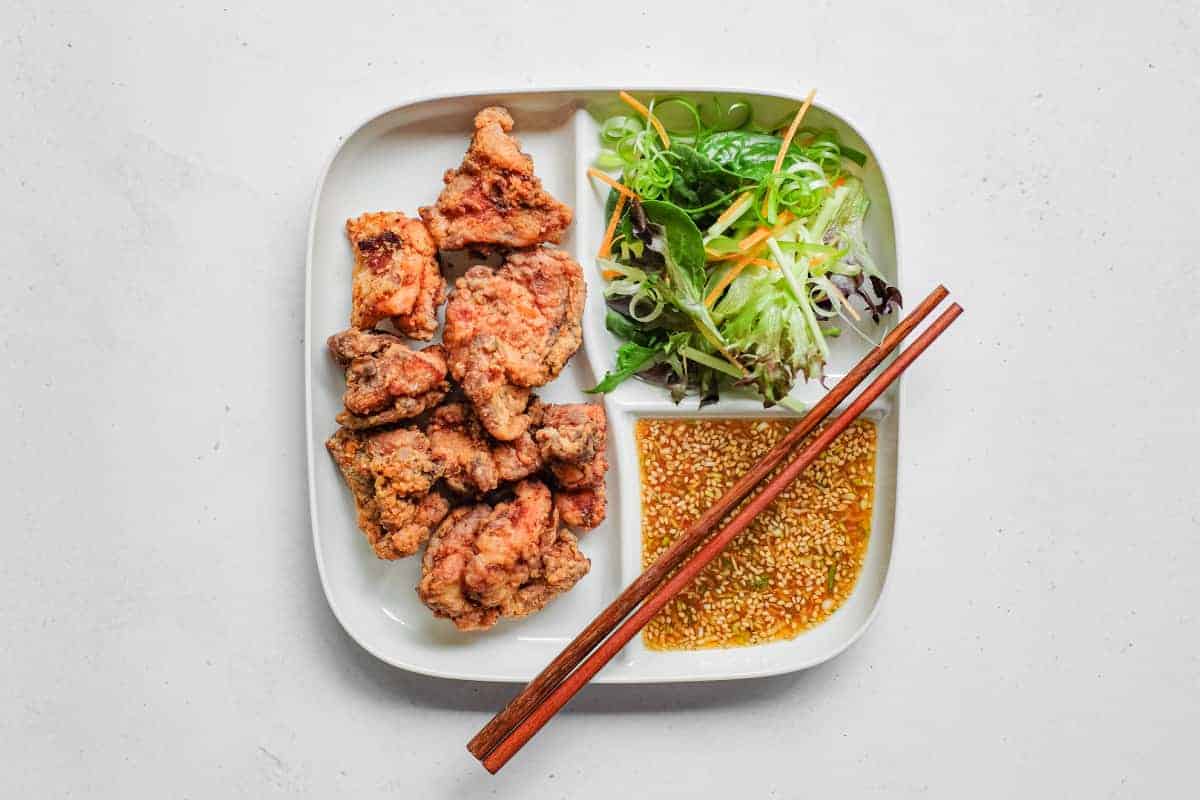 Yurinchi Chicken (Crispy Fried Chicken with Soy Vinegar Sauce) A separated plate which holds yurinchi chicken, crisp chicken, sauce and salad