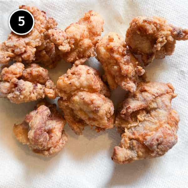 Yurinchi Chicken (Crispy Fried Chicken with Soy Vinegar Sauce) Karaage chicken draining on paper towels for yurinchi chicken.