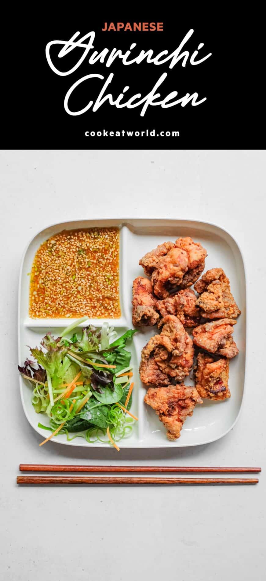 A bento plate holding yurinchi chicken and salad.