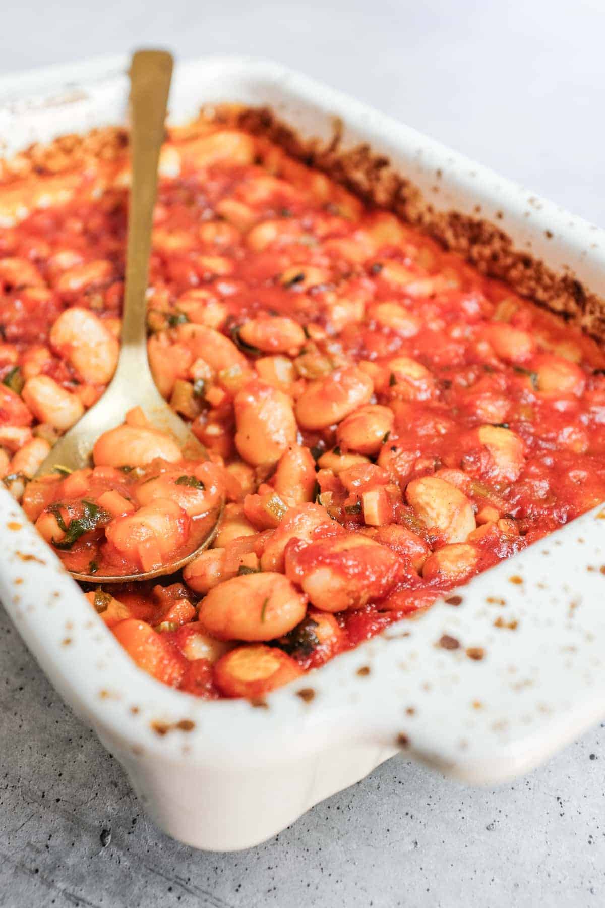 Gigantes plaki greek beans baked in tomato sauce with parsley.