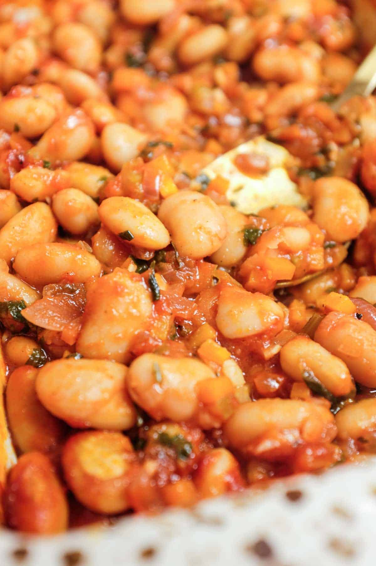 Mediterranean gigantes plaki butter beans in tomato sauce baking dish.