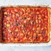 Rustic ceramic dish of gigantes plaki greek baked butter beans