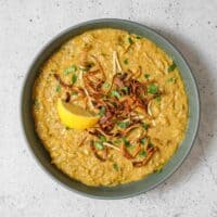 Rich haleem with tender lamb, topped with fried onions and fresh cilantro