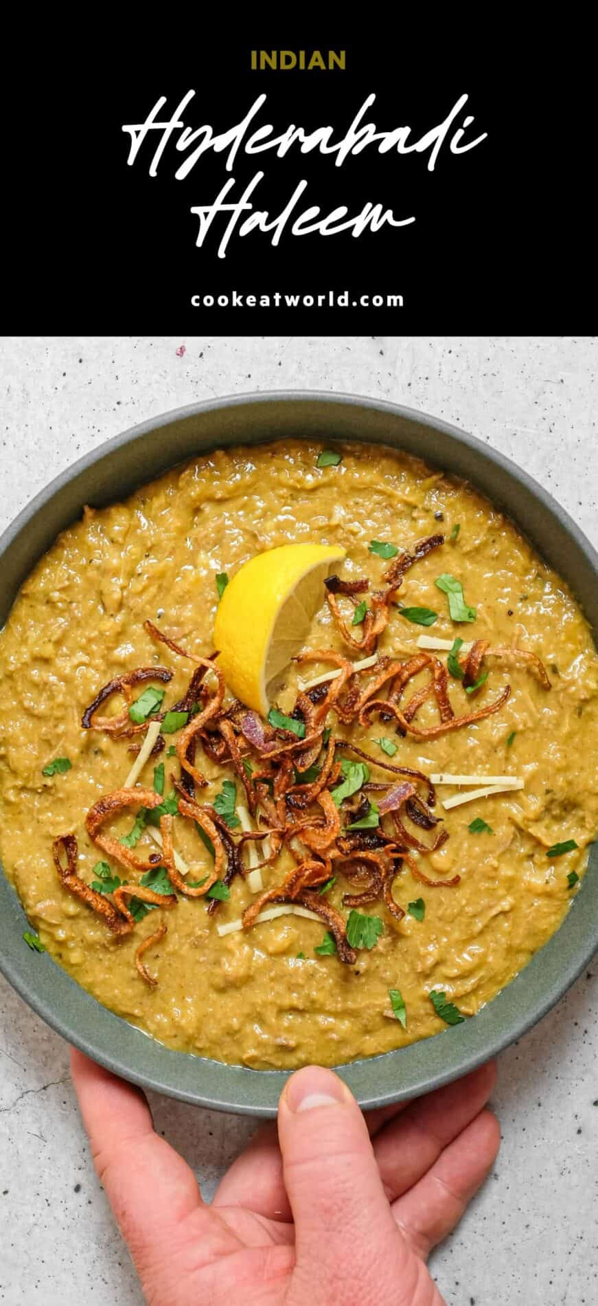 Bowl of Hyderabadi haleem topped with cilantro, mint, crispy onions and a lemon wedge