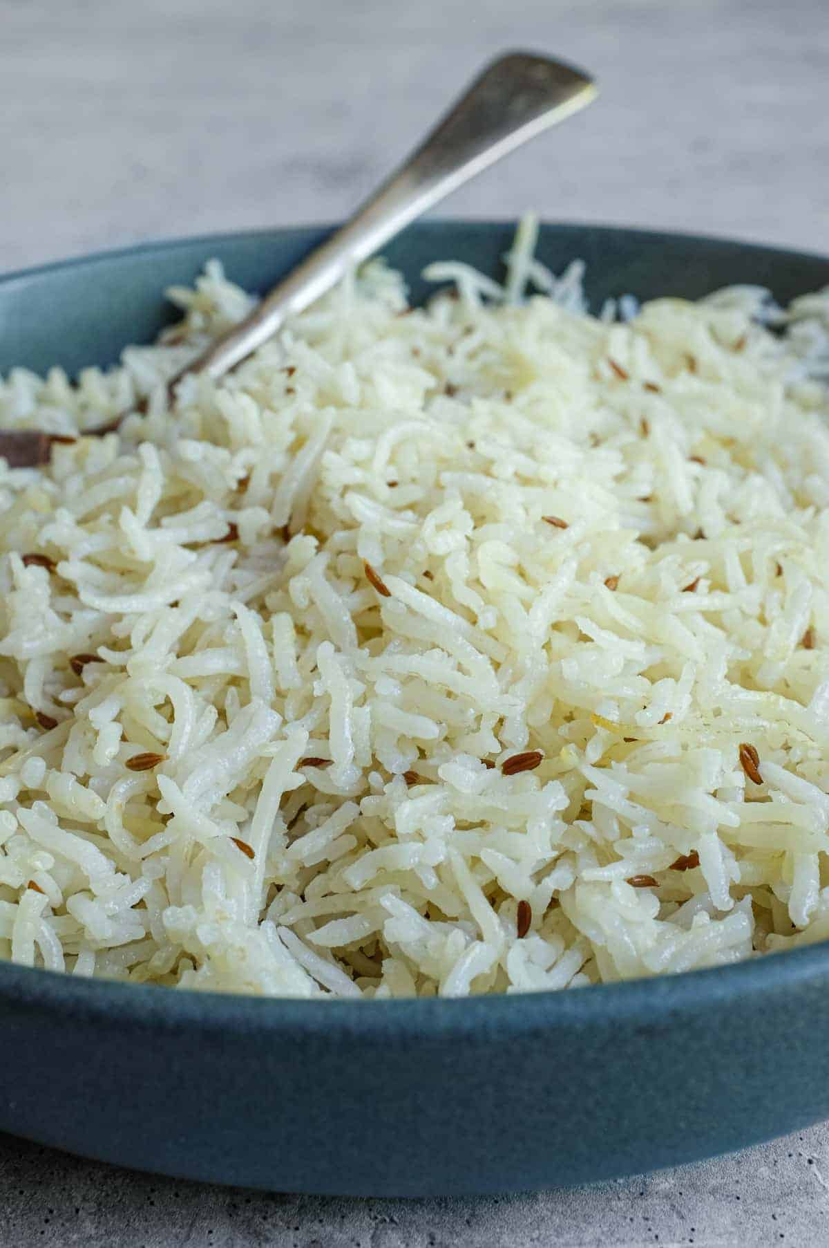 Steamed basmati rice infused with cumin seeds and subtle golden colour