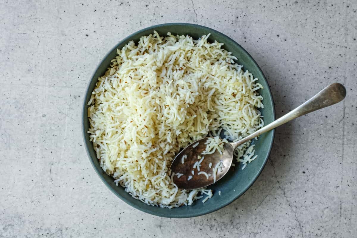 Homemade jeera rice with ghee and toasted cumin seeds in a serving bowl