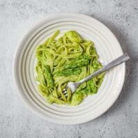 Homemade pesto pasta with potatoes and green beans served warm