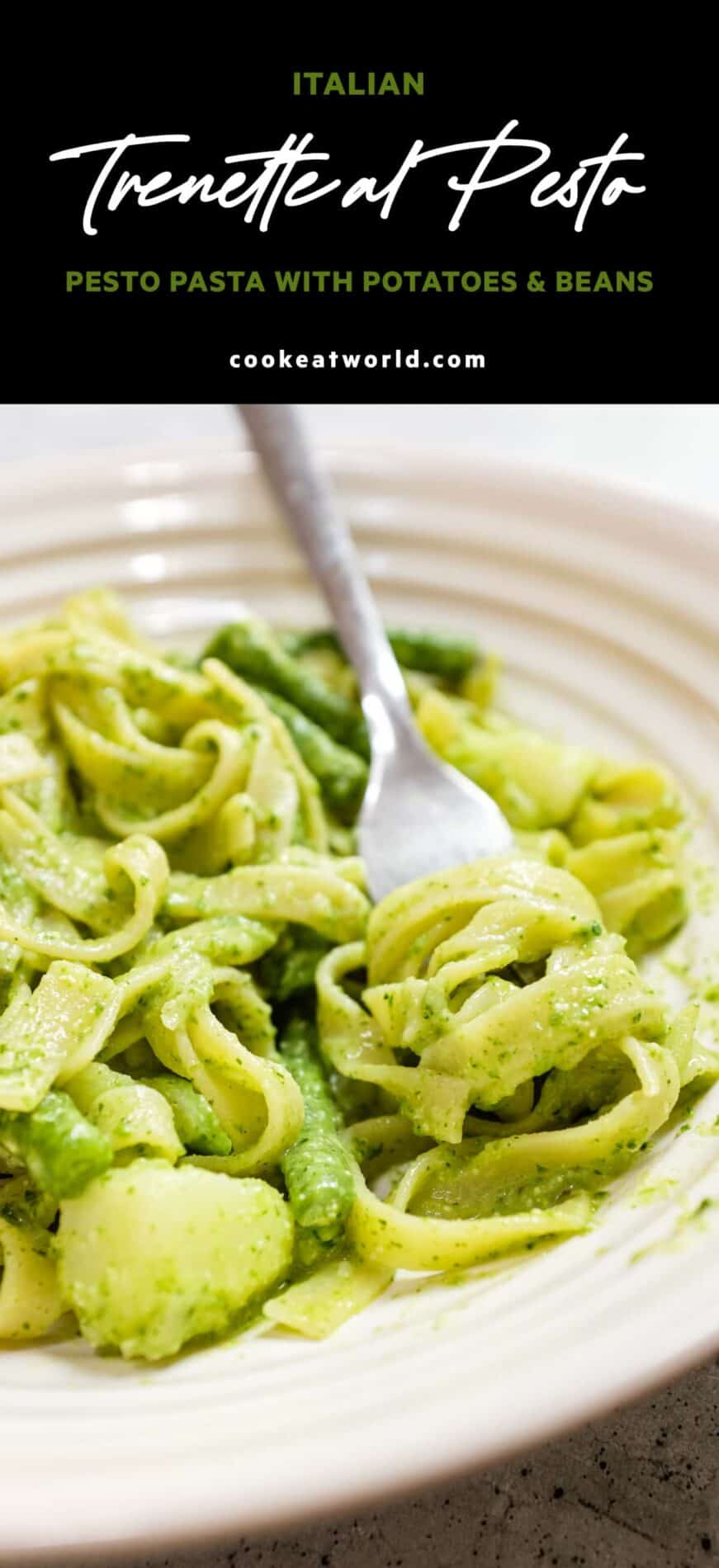 Pesto pasta with potatoes and green beans on a white plate
