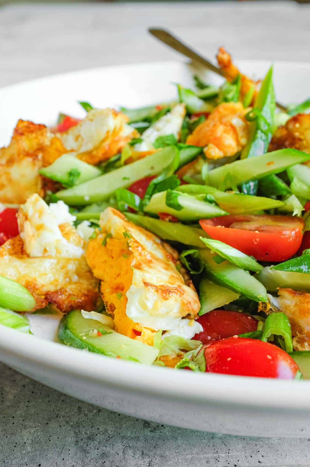 Golden fried eggs in Thai salad with crunchy vegetables