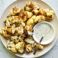 Arnabeet B’Tahini plated with charred cauliflower and sesame sauce
