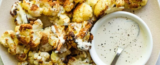 Arnabeet B’Tahini plated with charred cauliflower and sesame sauce