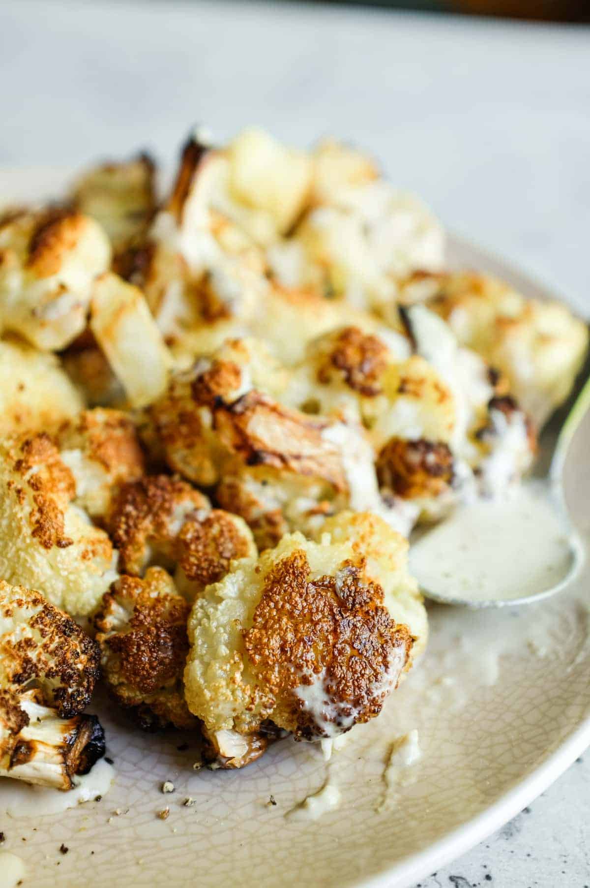 Golden roasted cauliflower with creamy sesame tahini drizzle