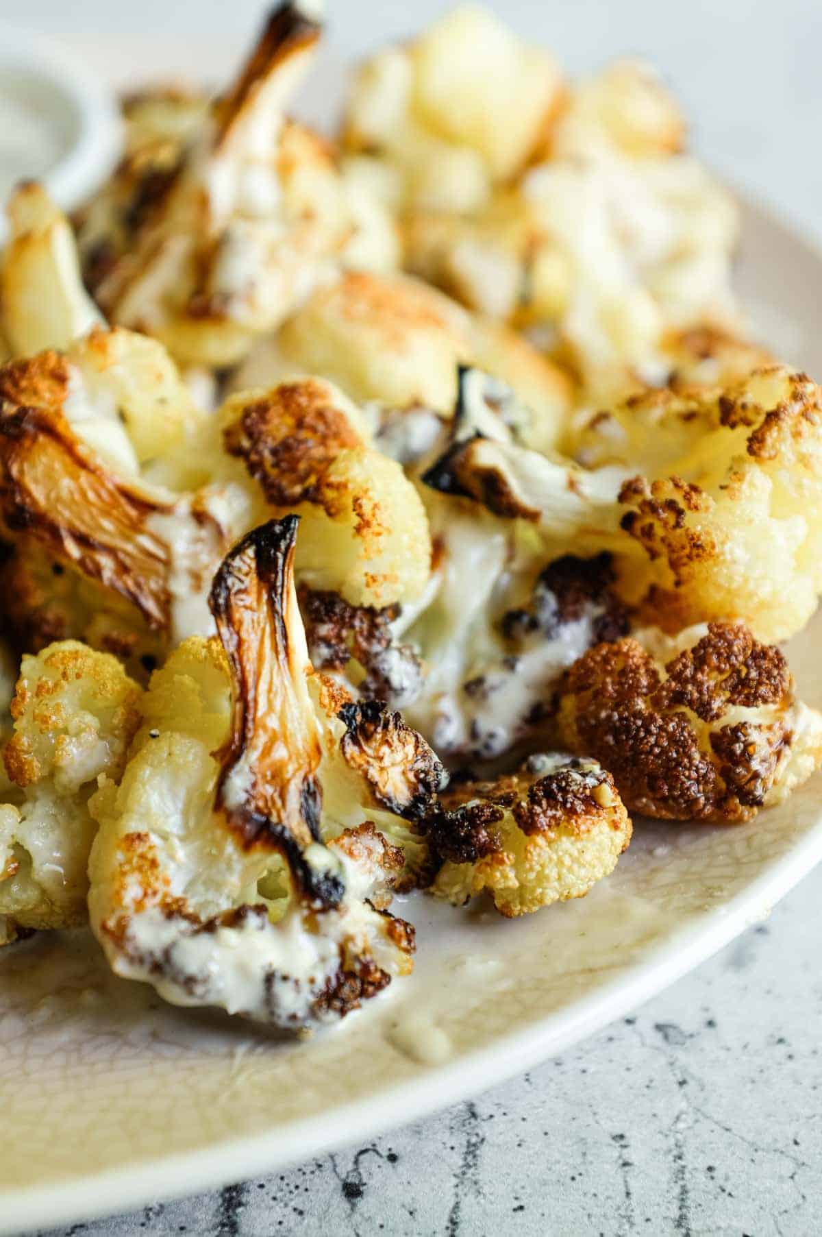 Crispy roasted cauliflower served with garlic tahini sauce