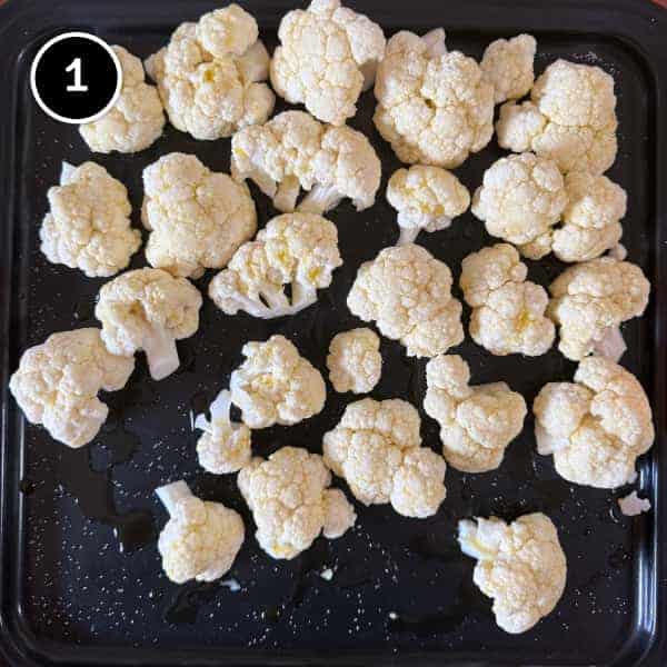 Lebanese Cauliflower with Tahini (Arnabeet b’Tahini) | cookeatworld.com Cauliflower florets on a baking tray, ready for roasting.