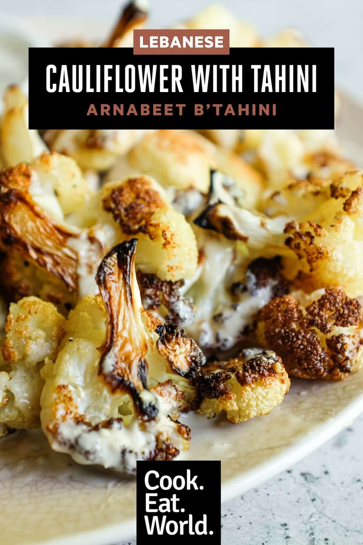 Close-up of roasted cauliflower drizzled with tahini and herbs
