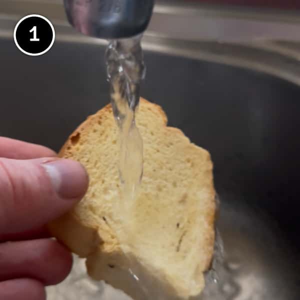 Cretan Dakos Salad | cookeatworld.com Running paximadia rusks under cold water to soften slightly