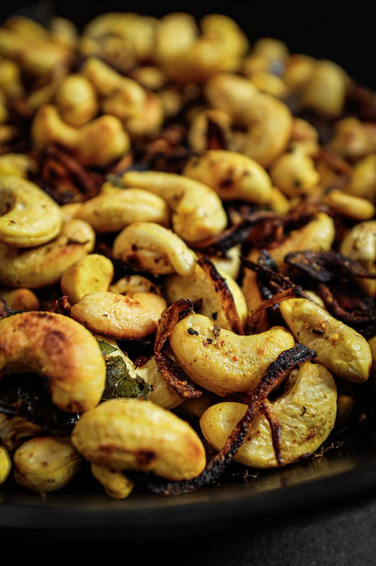 Crunchy South Indian curry leaf cashews served in a rustic bowl.