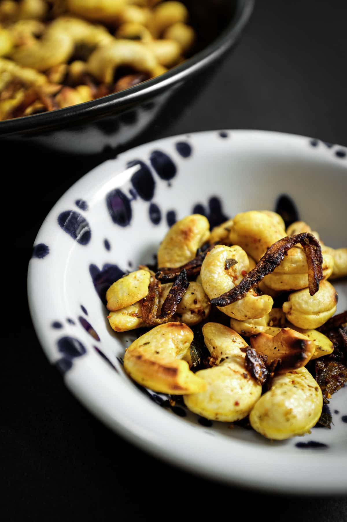 Freshly fried spicy cashew nuts served alongside Indian-inspired dishes.