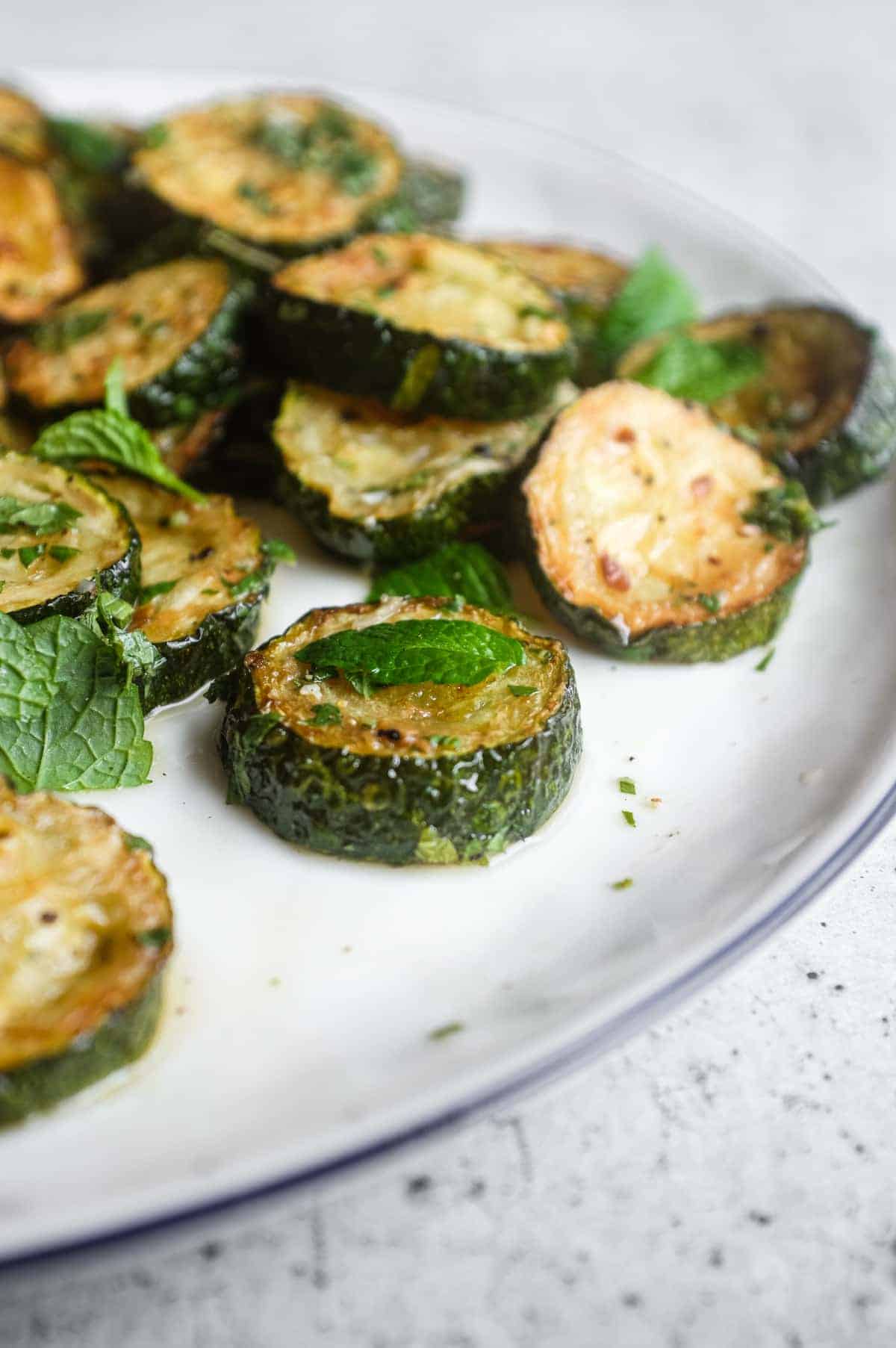 Golden zucchini slices marinated with white wine vinegar and garlic in a classic Campanian zucchini alla scapece recipe.