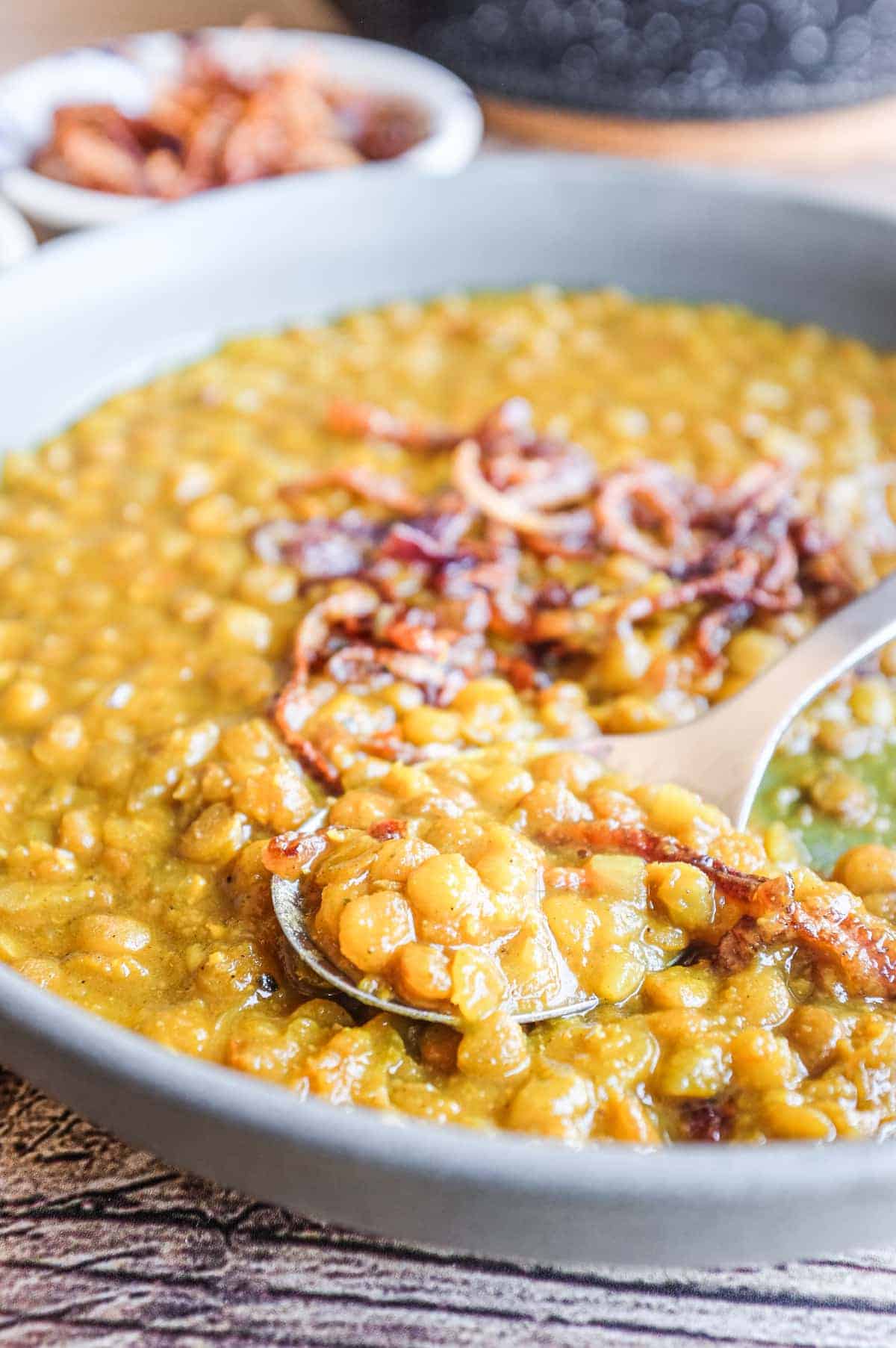 Close-up of silky adasi with whole green lentils and fried onions