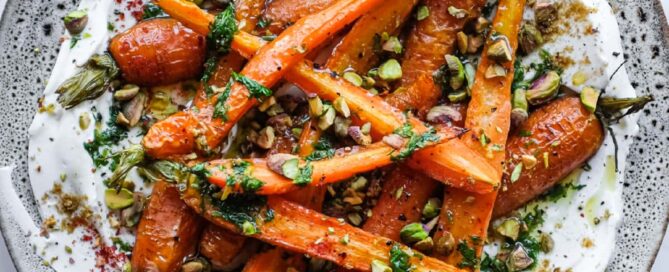 Roasted baby carrots served over creamy labneh with toasted pistachios, fresh dill and a drizzle of lemon dressing.