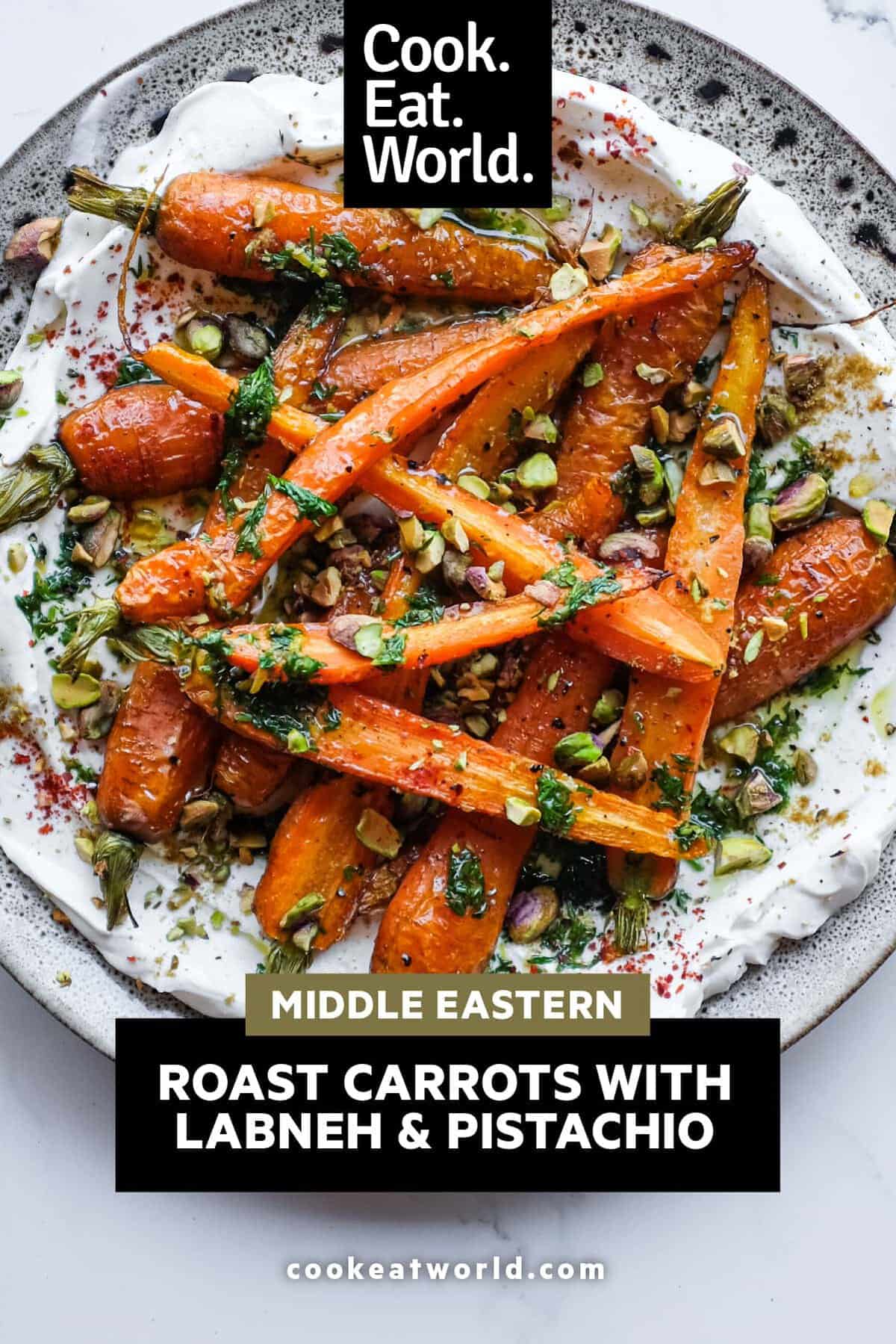 Roasted baby carrots with whipped labneh and toasted pistachios on a serving platter.