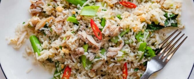 Overhead view of Vietnamese crab fried rice served with fresh lime wedges