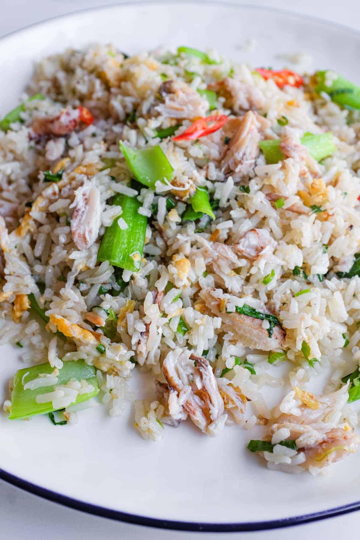 Overhead view of Vietnamese crab fried rice served with fresh lime wedges