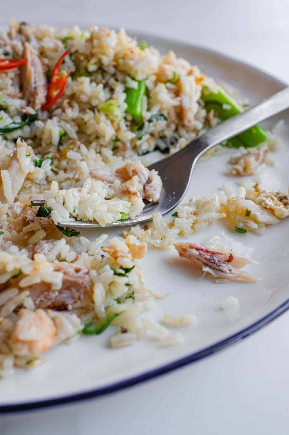 Bowl of Vietnamese crab fried rice topped with fresh cilantro and spring onions